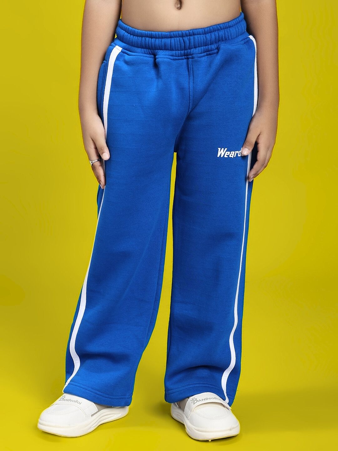 Child wearing RAPID STRIDE FLEECE JOGGER FOR BOYS AND GIRLS ROYAL BLUE with white stripe, perfect for comfort and style.
