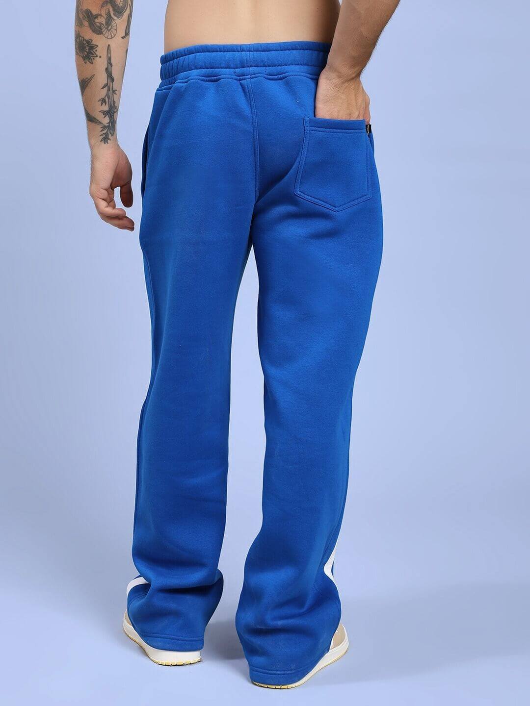 Side view of RAPID STRIDE FLEECE JOGGER ROYAL BLUE styled with sneakers.