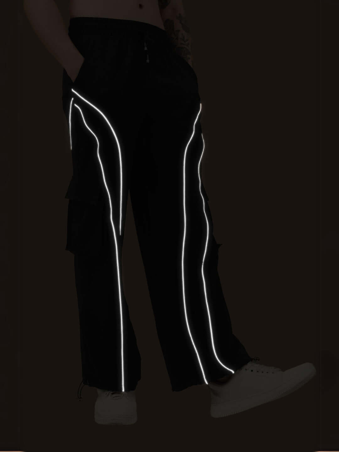 Black Ray Reflector Parachute Cargo Pants with reflective strips, customizable fit available for prepaid orders, shown with white sneakers.