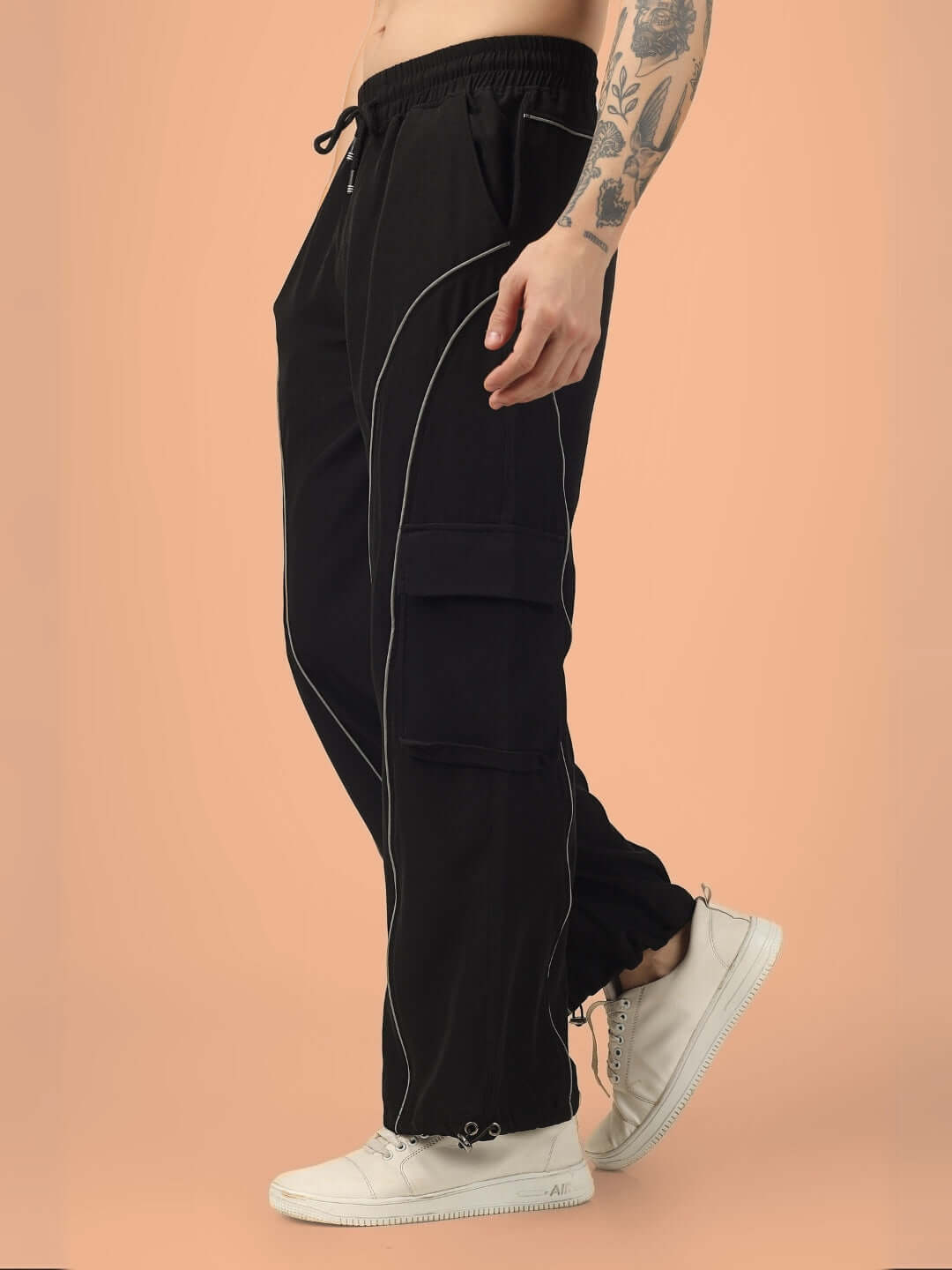 RAY Reflector Parachute Cargo Pants in black, featuring a relaxed fit with white stitching and side pockets, suitable for customization.