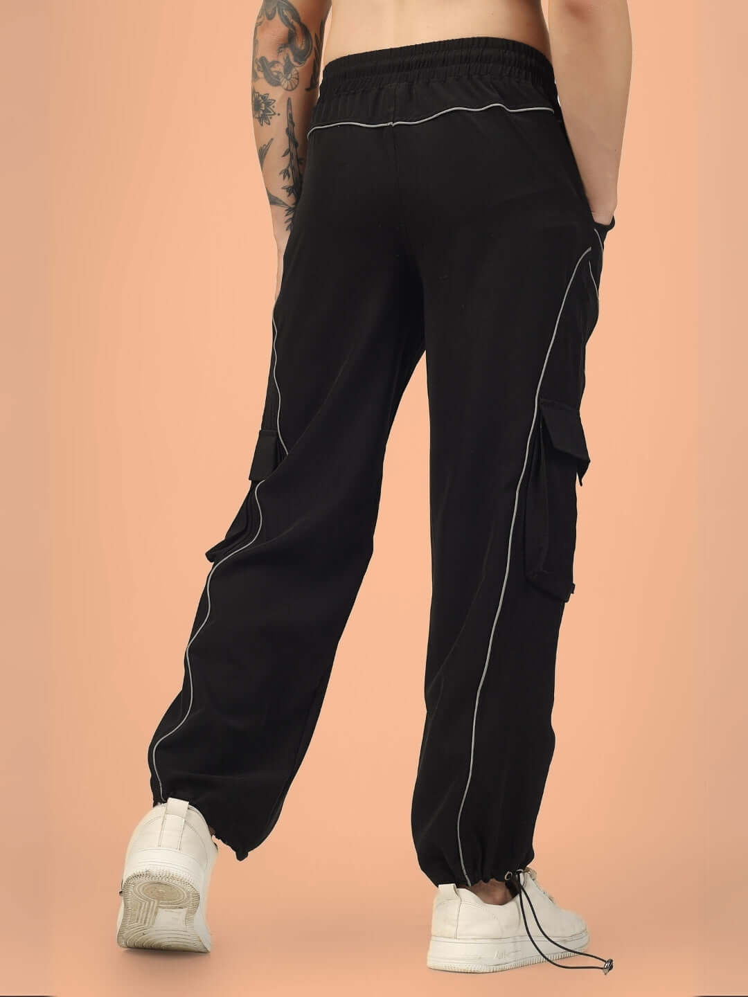 Black Ray Reflector Parachute Cargo Pants with elastic waistband and large side pockets, shown on a neutral background.