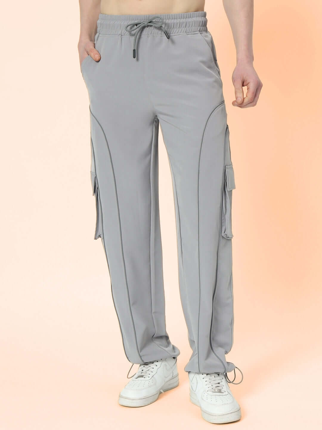 RAY Reflector grey parachute cargo pants with customizable fit option, featuring side pockets and drawstring waist, ideal for casual style.