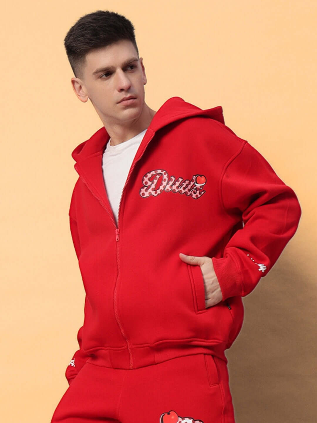 Man wearing CUPCAKE COTTON FLEECE HOODIE RED showcasing bold streetwear style with distinctive designs.