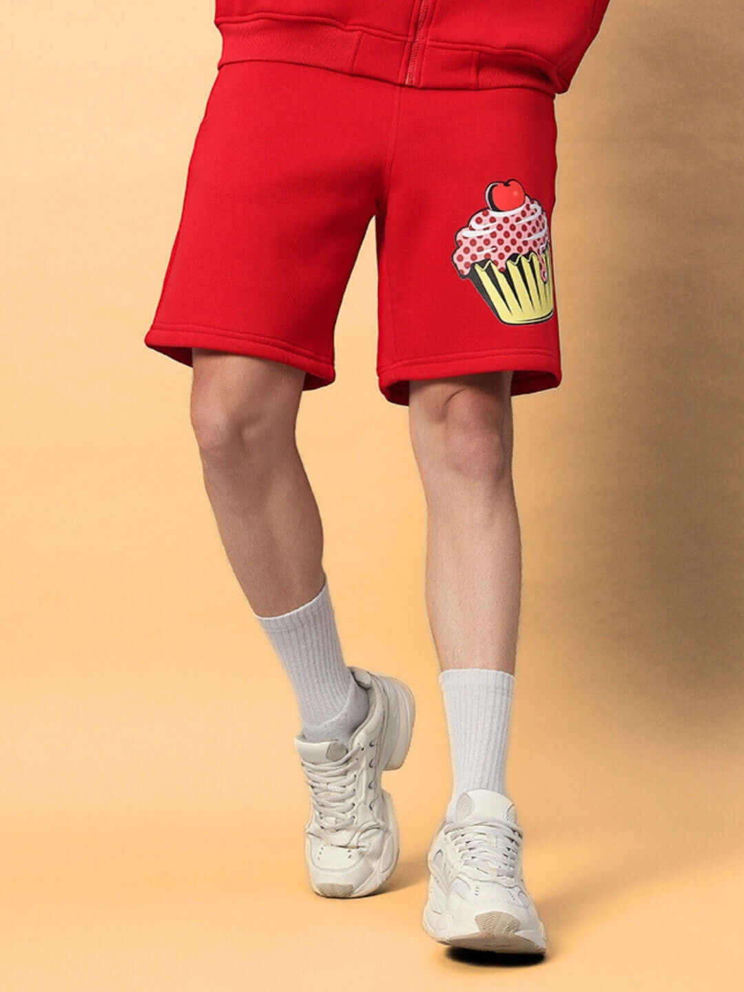 Person wearing CUPCAKE COTTON FLEECE SHORTS RED with cupcake design.