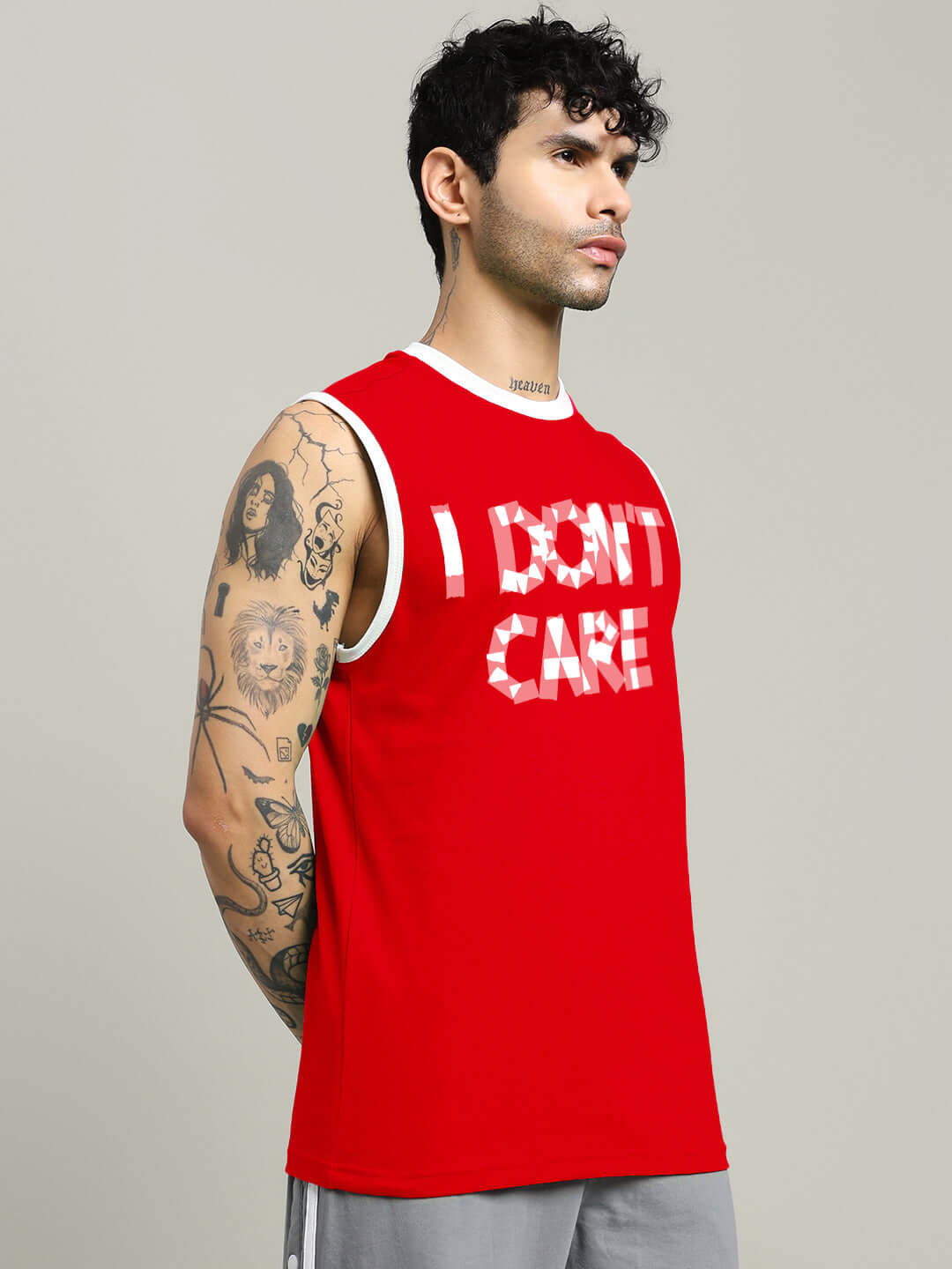 Model wearing red 'I DON'T CARE' gym t-shirt, available in Custom Fit for prepaid orders.