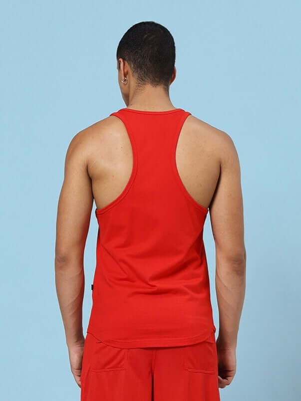 Back view of man wearing EXCUSES DON'T BURN CALORIES PRINTED GYM T-SHIRT RED, showcasing sleeves and fit.