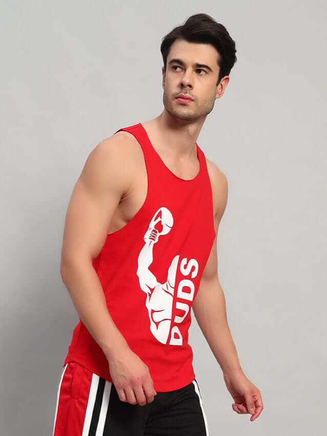 Man wearing a red tank top with a bold print, ideal for gym wear and fitness enthusiasts.