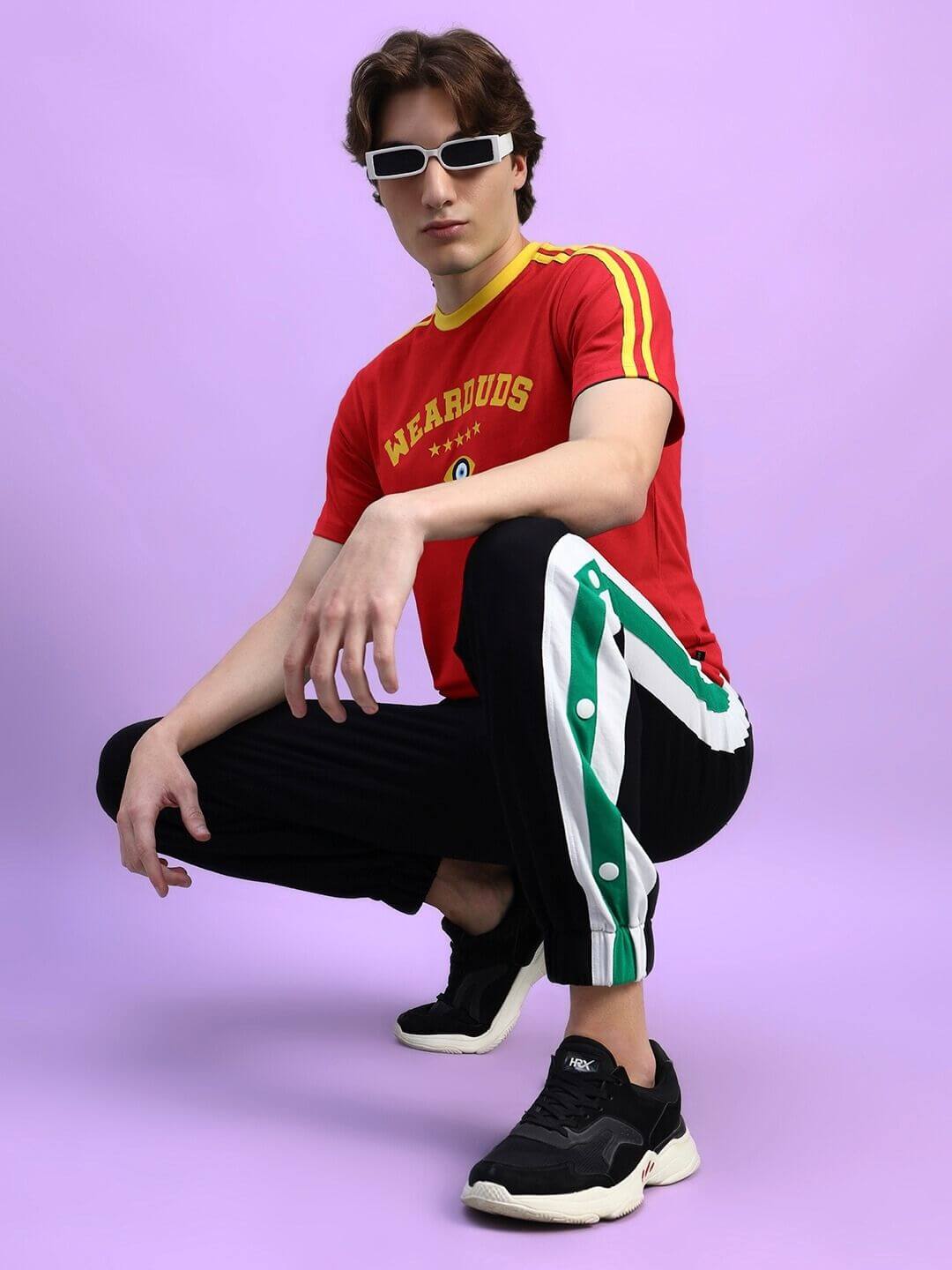 Person wearing IRISH REGULAR FIT T-SHIRT IN RED with sporty black and green pants.