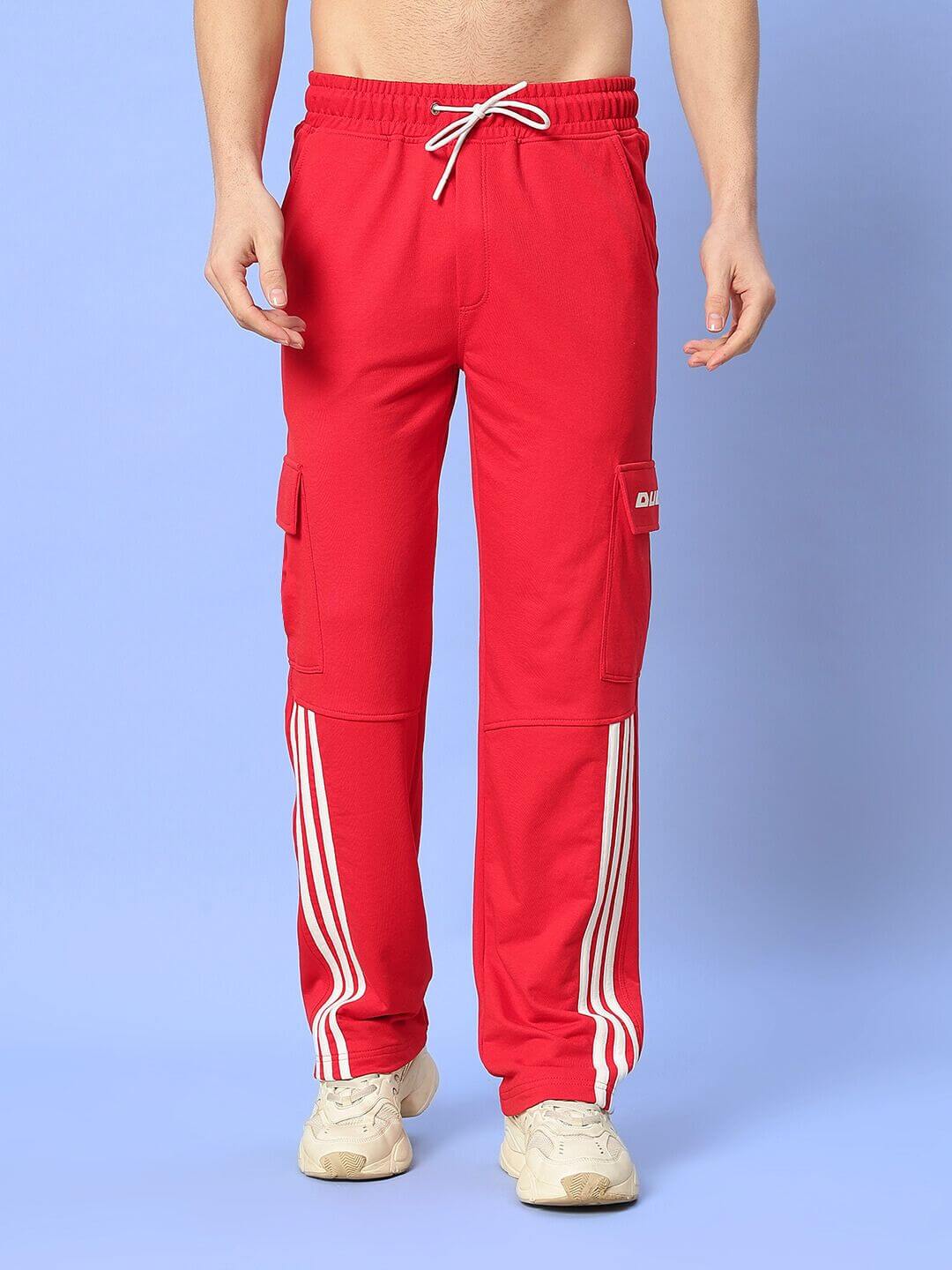 Person wearing red joggers with side pockets and white stripes, demonstrating the Ricky Relaxed Fit Co-Ord Set in white-red.