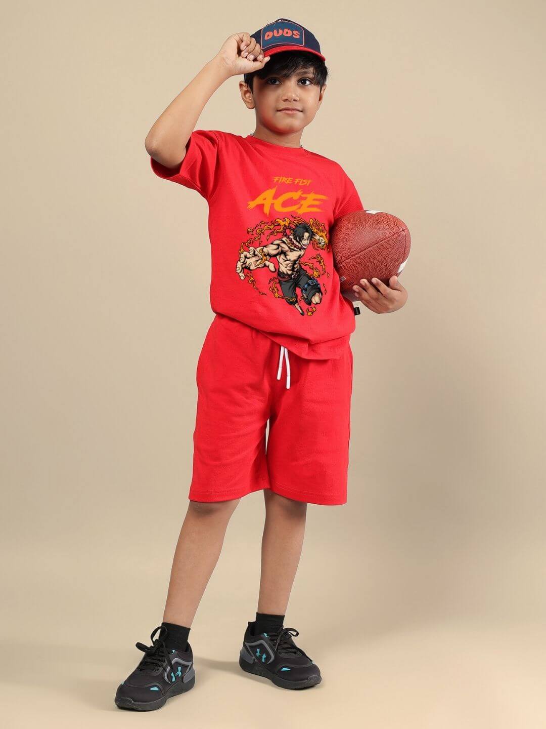 Child wearing ACE CO-ORD FOR BOYS AND GIRLS RED outfit holding a football