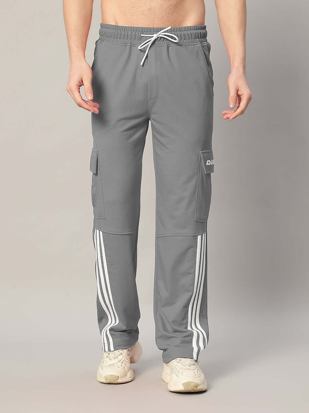 Model wearing grey REDROIT 5 Pocket Relaxed Fit Joggers from DUDS featuring side stripes and cargo pockets.