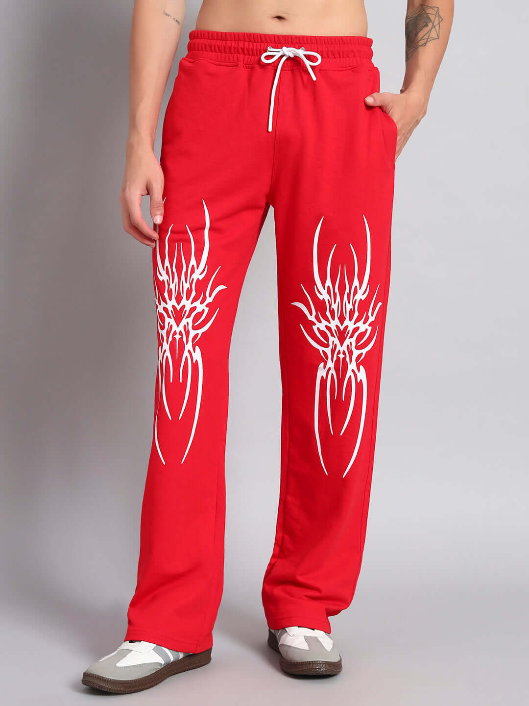 Man wearing REDX BRANCHING COTTON JOGGER RED MEN with white drawstring and unique design, showcasing front view.