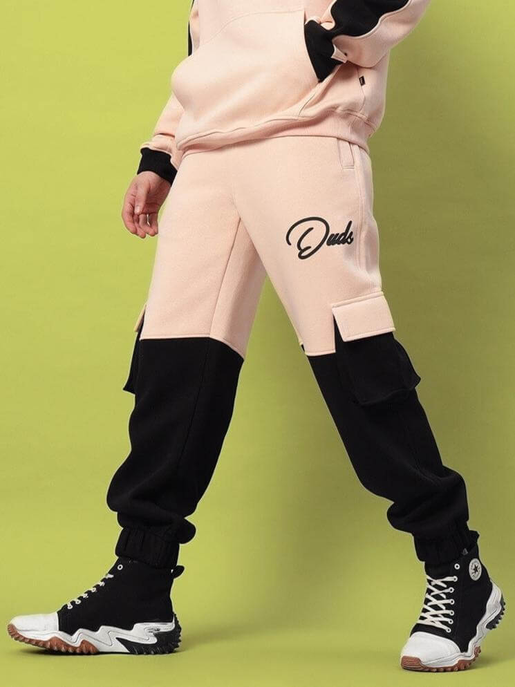 Person wearing Regiment Fleece Co-Ord Beige Black set, showcasing hoodie and joggers with chic beige-black design, modern streetwear style.