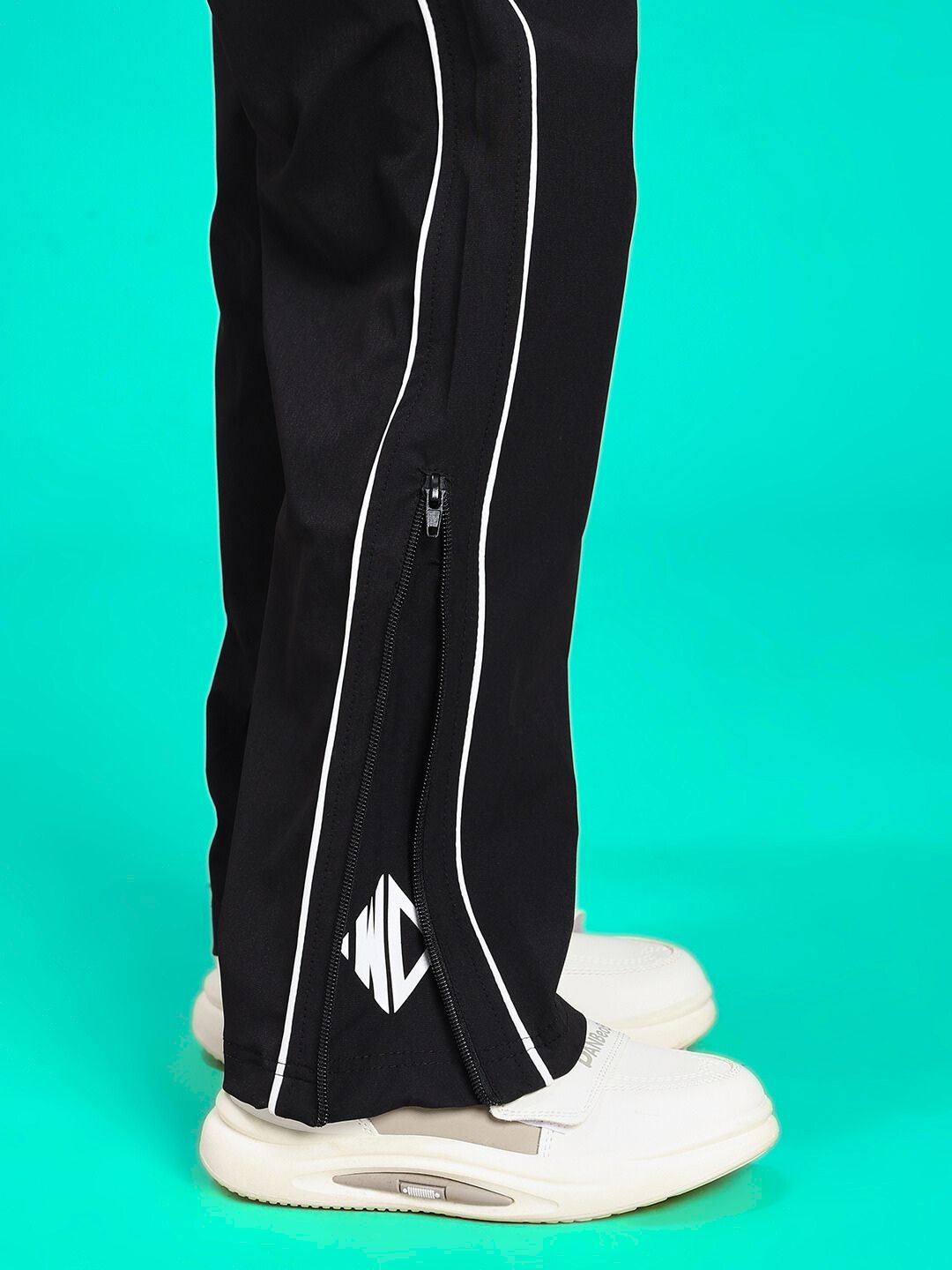RELIGHT RELAXED FIT CO-ORD SET FOR BOYS AND GIRLS BLACK pants with zipper detail shown with white sneakers.