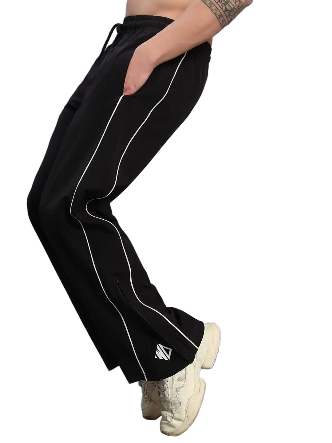 Person wearing RELIGHT RELAXED-FIT JOGGERS BLACK with white stripe detail, showcasing comfort and style. Custom fit available for prepaid orders.