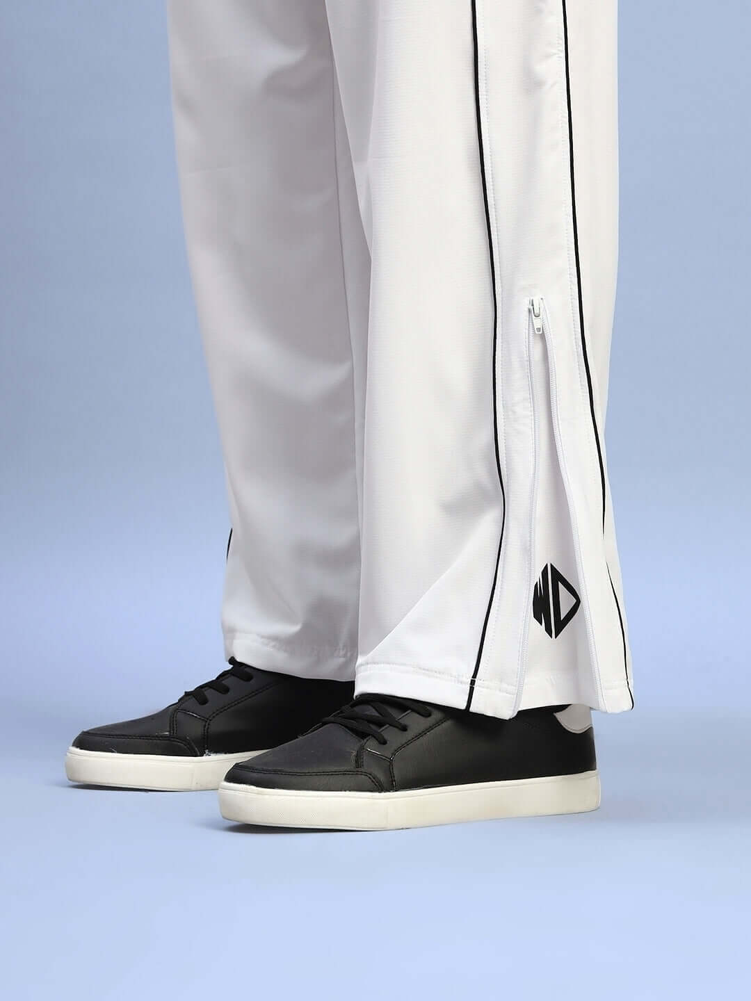 White relaxed-fit joggers with black shoes, featuring a custom fit option by DUDS for a comfortable and tailored experience.