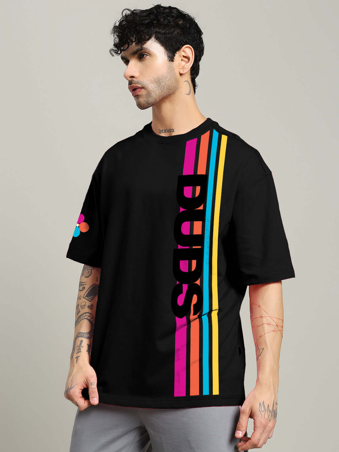 Male model wearing RETRO STRIPES OVERSIZED T-SHIRT BLACK with colorful stripe design.