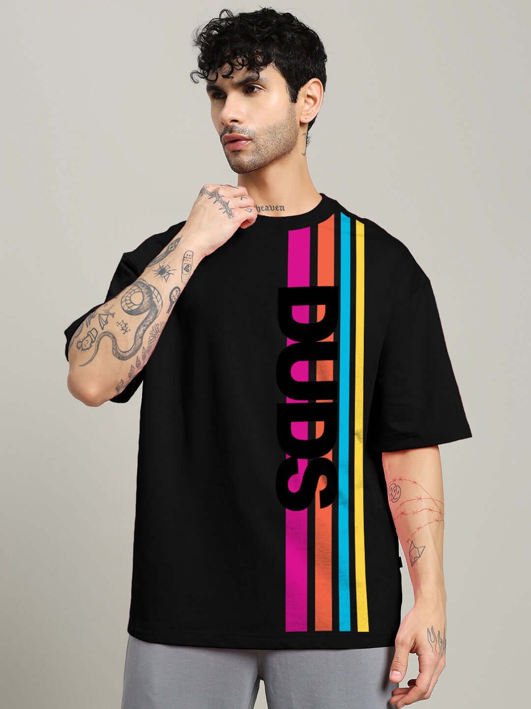 Model wearing Retro Stripes Oversized Black T-shirt with colorful vertical stripes made of premium cotton French terry fabric.