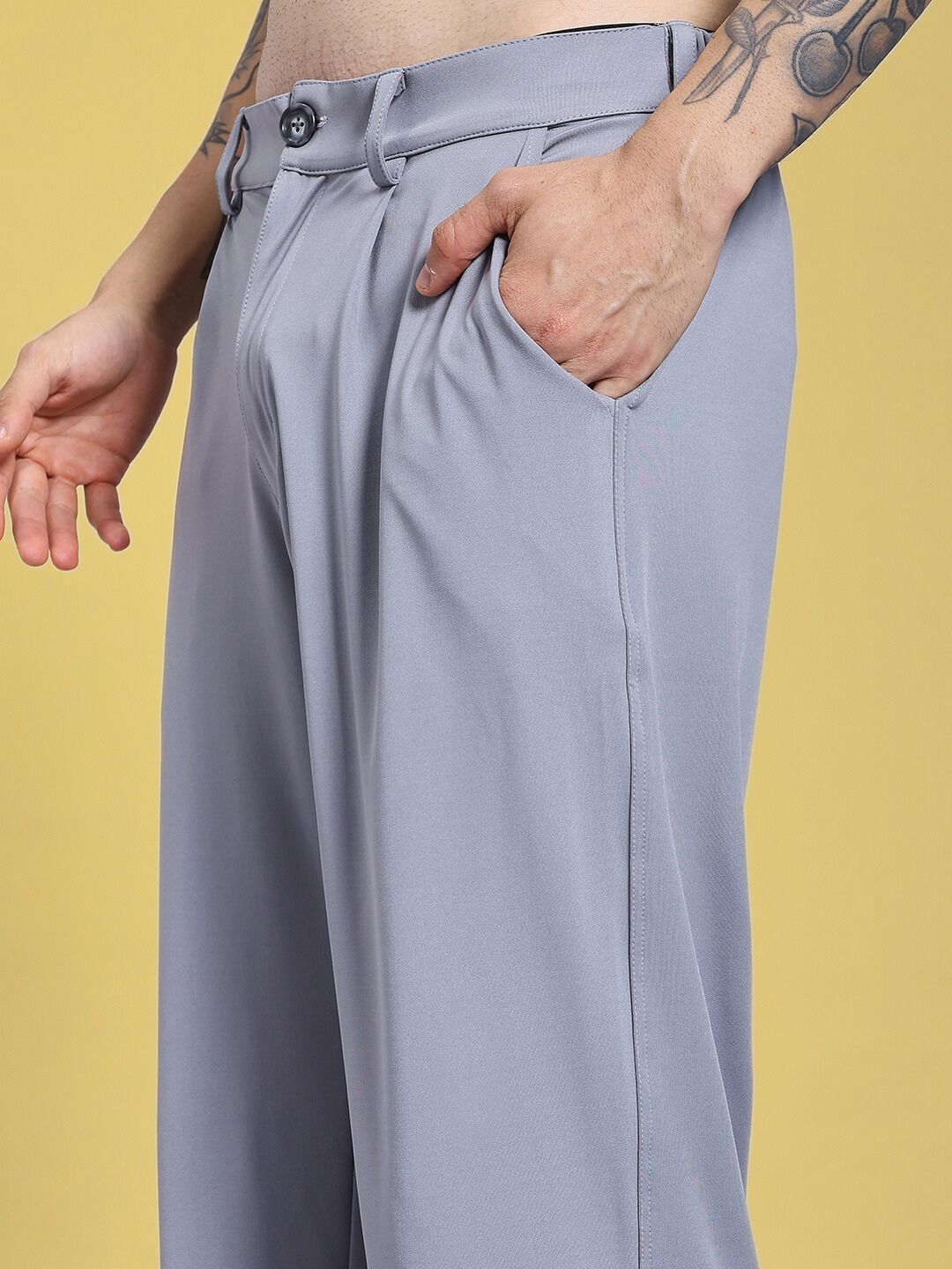 Person wearing REVOXX RELAXED FIT JOGGER GREY showcasing premium flex-blend fabric, front view with hand in pocket.