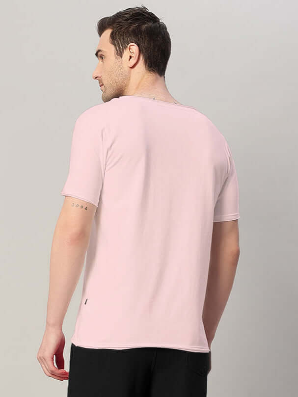Back view of a model wearing a Ricky Regular Fit T-Shirt in baby pink, made from premium 100% cotton, 190 GSM fabric.