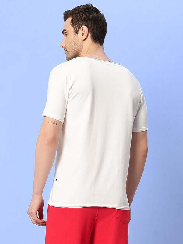 Rear view of a man wearing a Ricky Regular Fit White T-Shirt showing fabric and fit against a light blue backdrop.