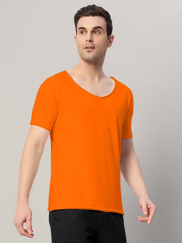 Man wearing RICKY REGULAR FIT T-SHIRT ORANGE, showcasing a vibrant and stylish wardrobe essential with a classic regular fit.