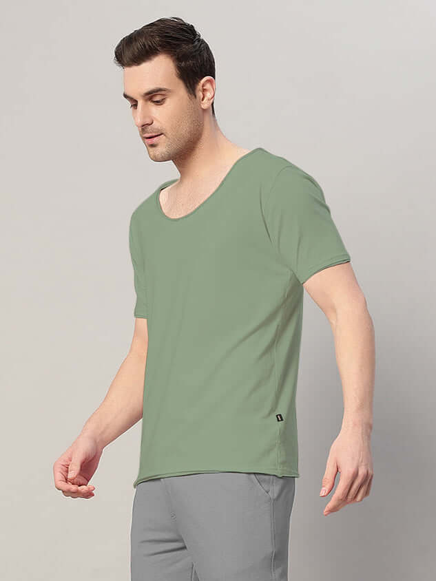 Man wearing a sage green Ricky regular fit t-shirt made of 100% cotton, bio-washed. Premium quality, 190 GSM fabric.