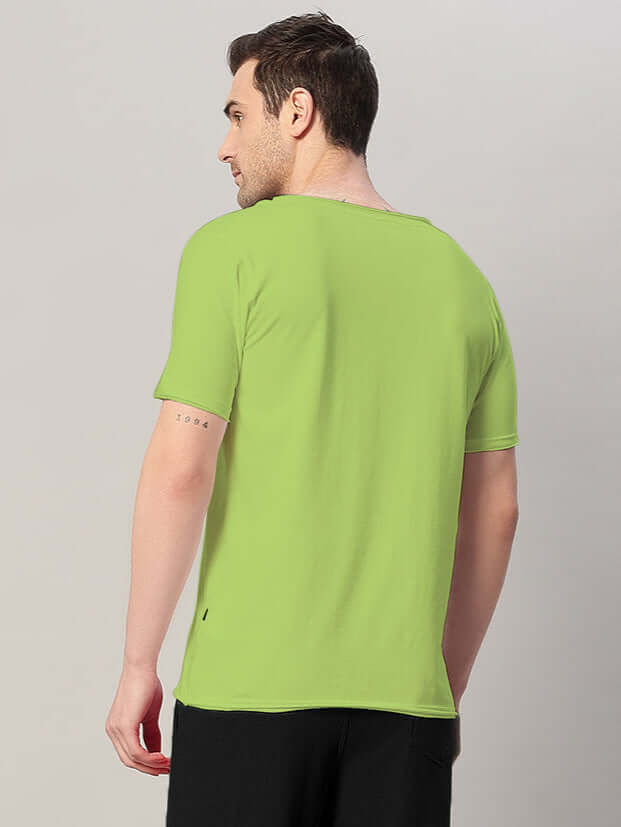 Back view of a man wearing a neon green Ricky Regular Fit T-Shirt, made from 100% cotton, showcasing its premium fabric quality.