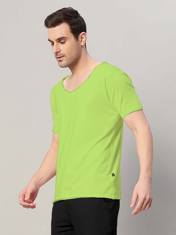 Model wearing Ricky regular fit neon green t-shirt made of 100% cotton, designed in India, highlighting comfort and style.