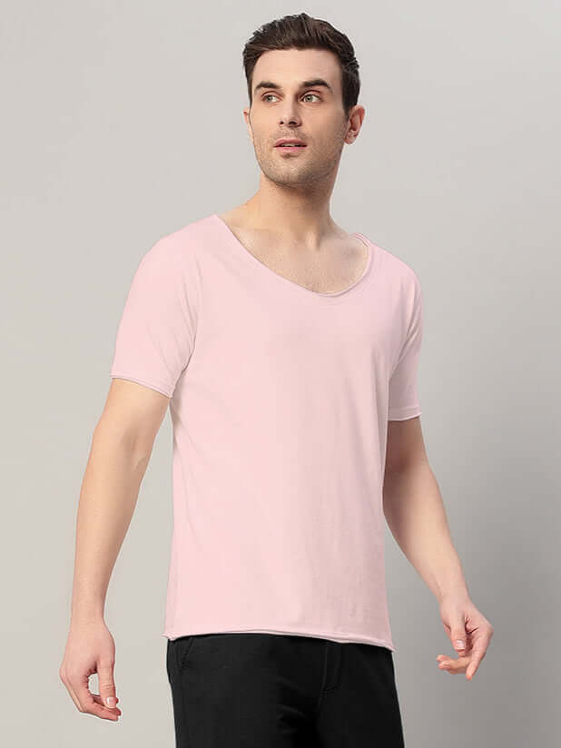 Model wearing Ricky Regular Fit T-Shirt in baby pink, made from 100% cotton with premium heavy gauge fabric, 190 GSM, India origin.