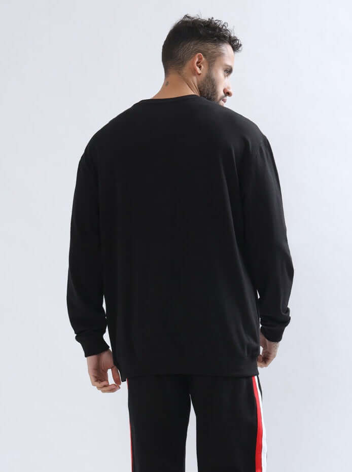 Man wearing RIGHTMAN Oversized Sweatshirt in black, featuring premium cotton blend fabric with a comfortable fit, showcased from the back.