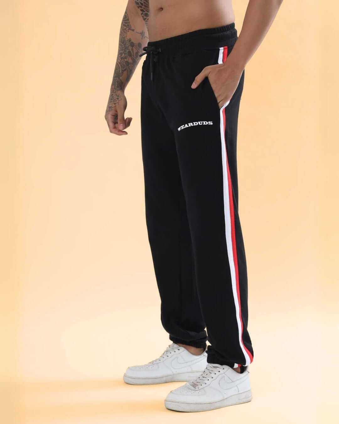 RIGHTMAN Jogger in black with red and white side stripes, designed for comfort and style by DUDS. Made to order.