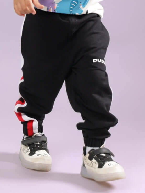 Child wearing RIGHTMAN JOGGER FOR BOYS & GIRLS BLACK styled for urban streetwear with comfortable sneakers.