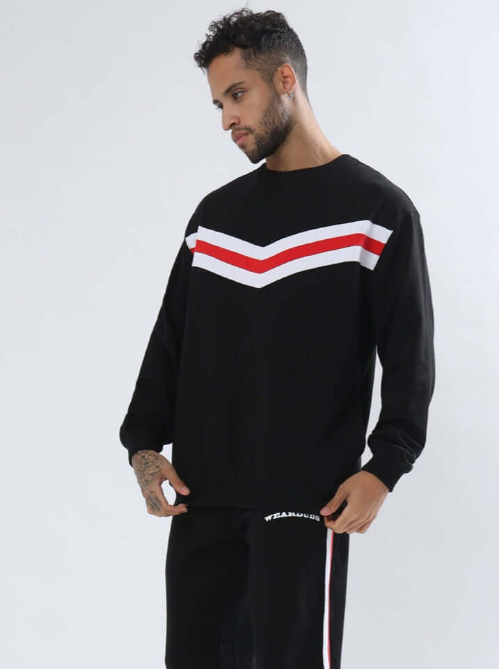 Model wearing RIGHTMAN oversized sweatshirt in black with red and white stripe pattern, made from premium cotton French terry fabric.