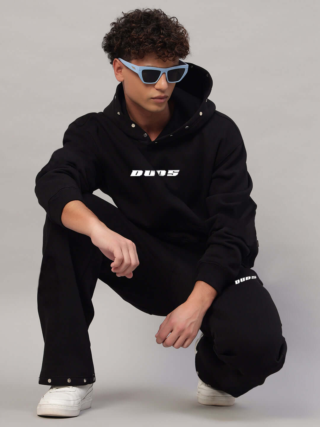 Model wearing WEARDUDS RIGID FLEECE HOODIE BLACK, stylish and comfortable hoodie made to order by DUDS.