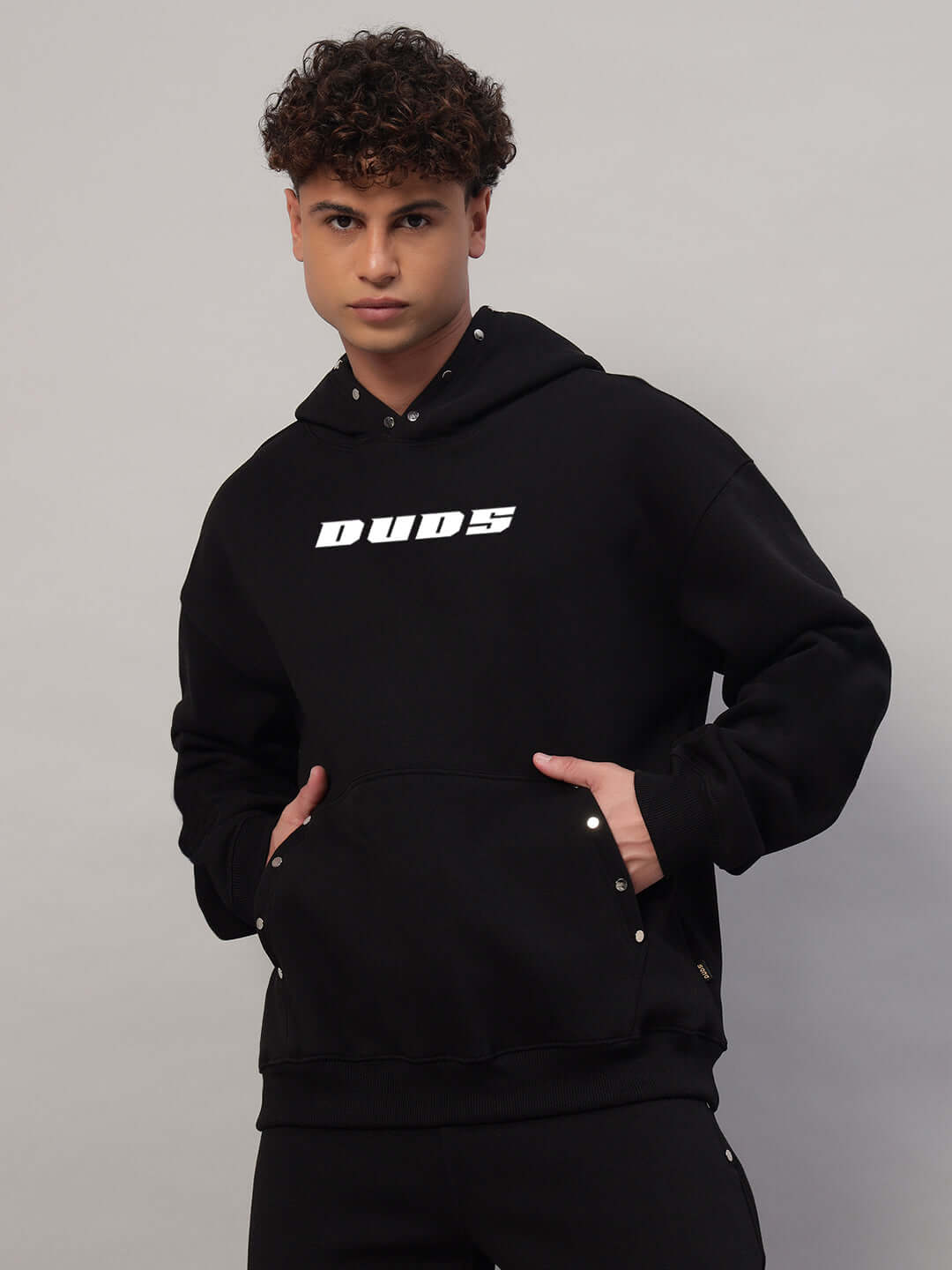 Model wearing WEARDUDS RIGID FLEECE HOODIE BLACK, designed for style and comfort, front view.