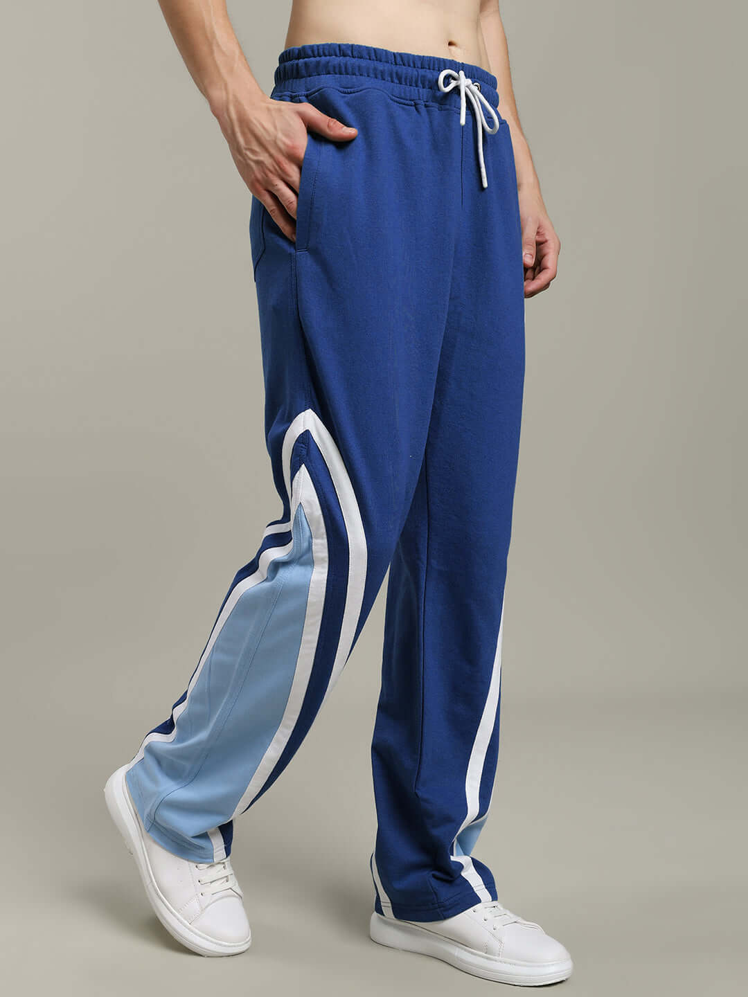 Man wearing RIO ONE relaxed fit blue joggers with drawstring, showcasing comfort and style.