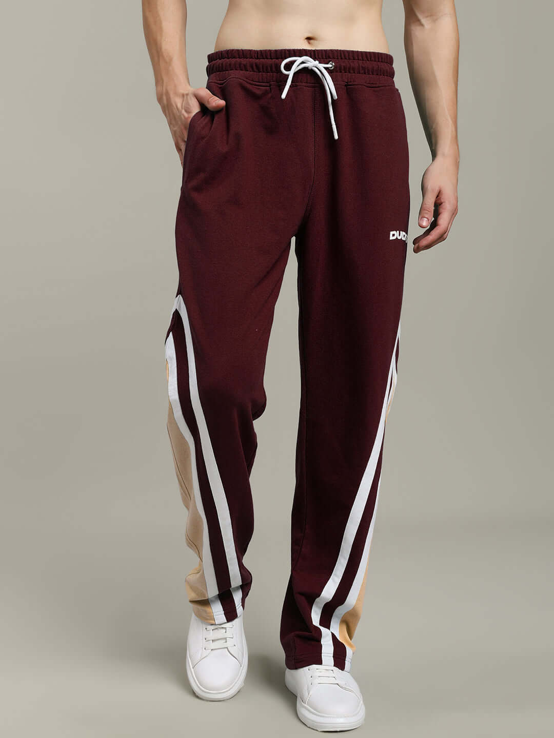 Men wearing RIO ONE relaxed fit joggers in brown with stripe detail, perfect for comfortable, custom-fit casual wear by DUDS.