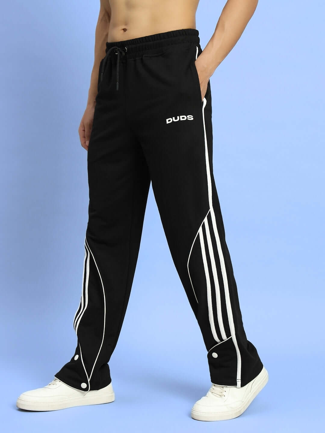 Model wearing black Ripple Contrast Joggers with white stripes, made with dedication by experienced DUDS tailors, available for custom fit.