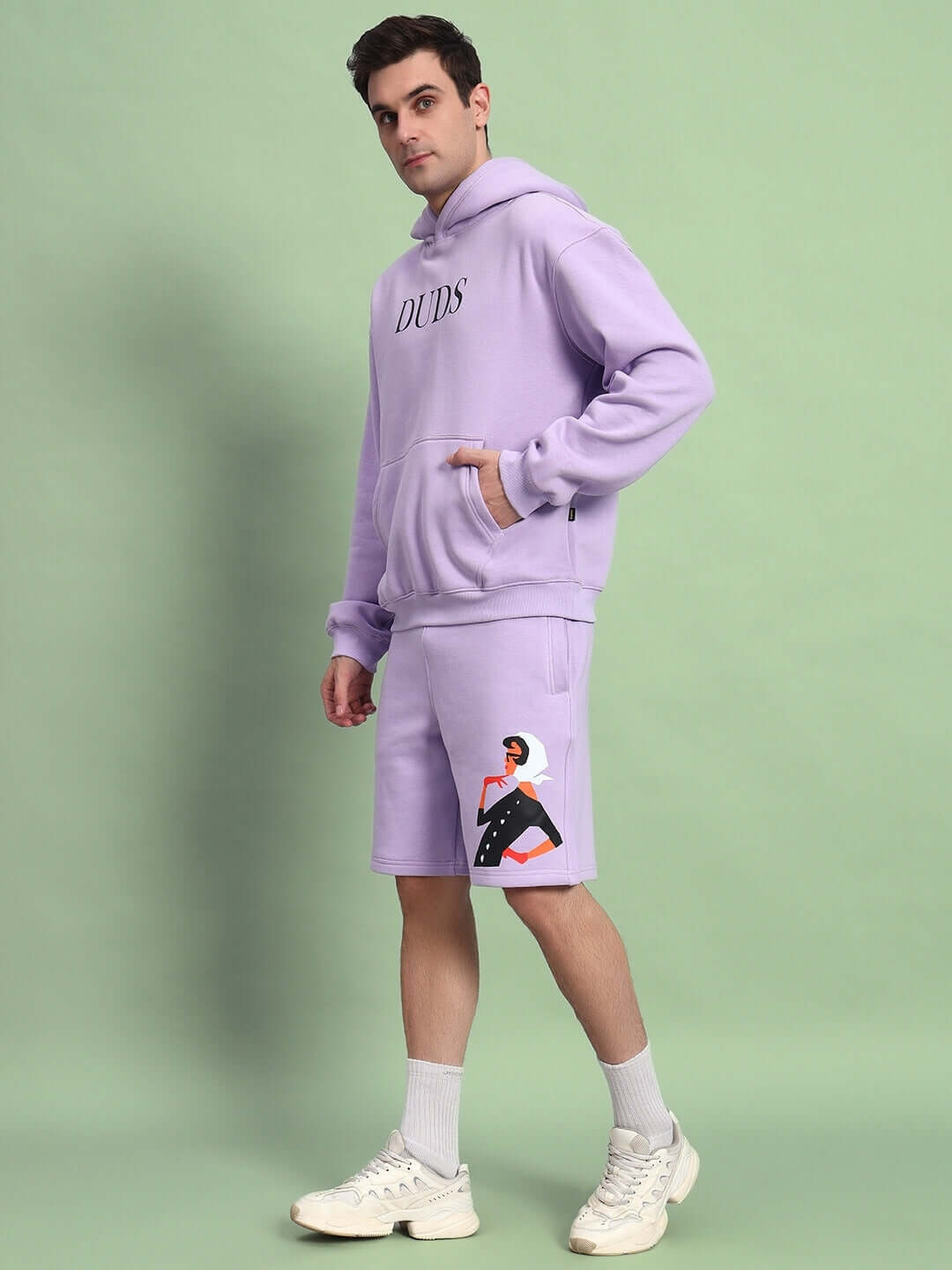 Model wearing WEARDUDS RITZY FLEECE CO-ORD LILAC, featuring hooded top and shorts with graphic, made by DUDS tailors. Custom fit available.