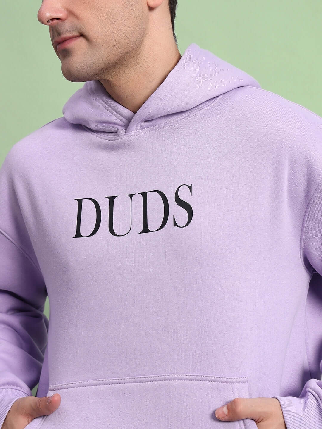 Man wearing WEARDUDS RITZY FLEECE HOODIE LILAC with DUDS logo, showcasing cozy custom fit option, product takes 7-10 days to dispatch, made to order.