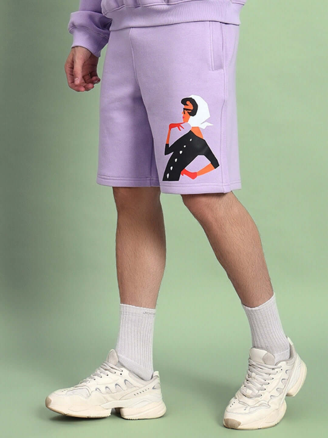 Man wearing WEARDUDS RITZY FLEECE SHORTS LILAC with a stylish print, showcasing casual street style.
