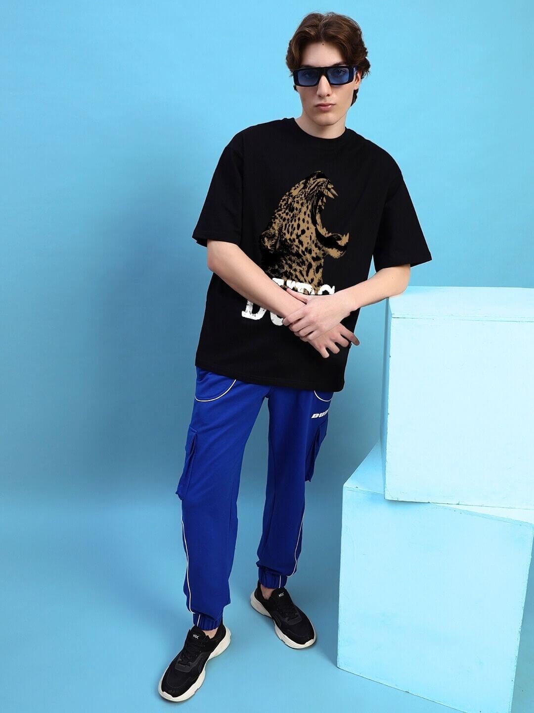 Model wearing ROARING THUNDER PRINTED OVERSIZED T-SHIRT BLACK with bold graphic