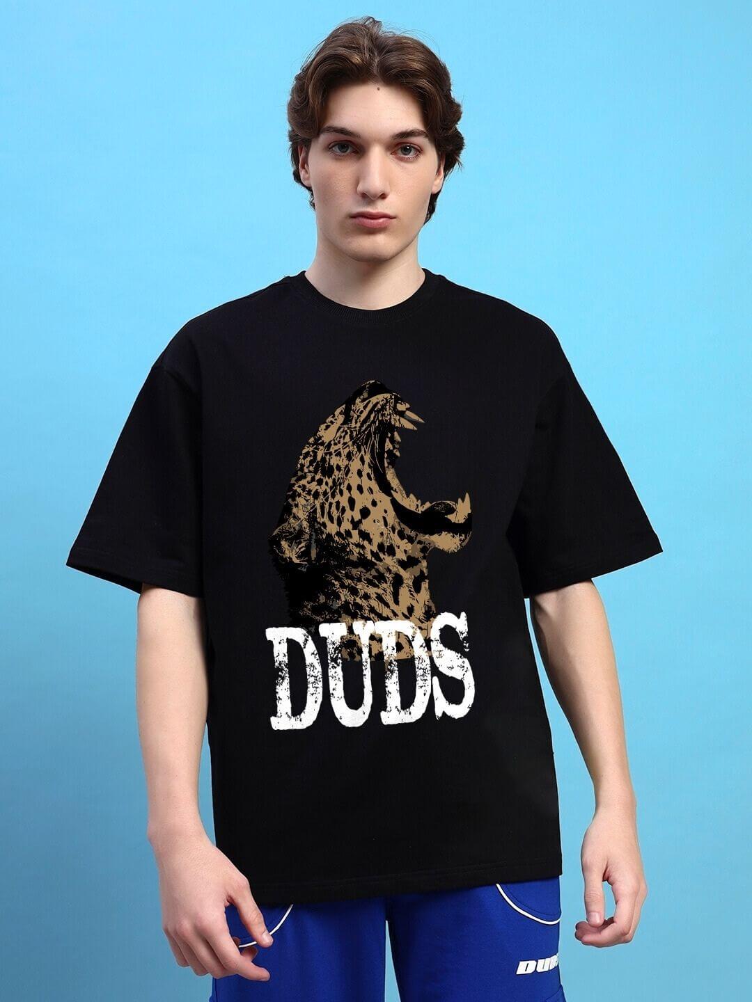 Model wearing black 'Roaring Thunder' oversized T-shirt with printed roaring leopard design, made from premium cotton blend fabric.