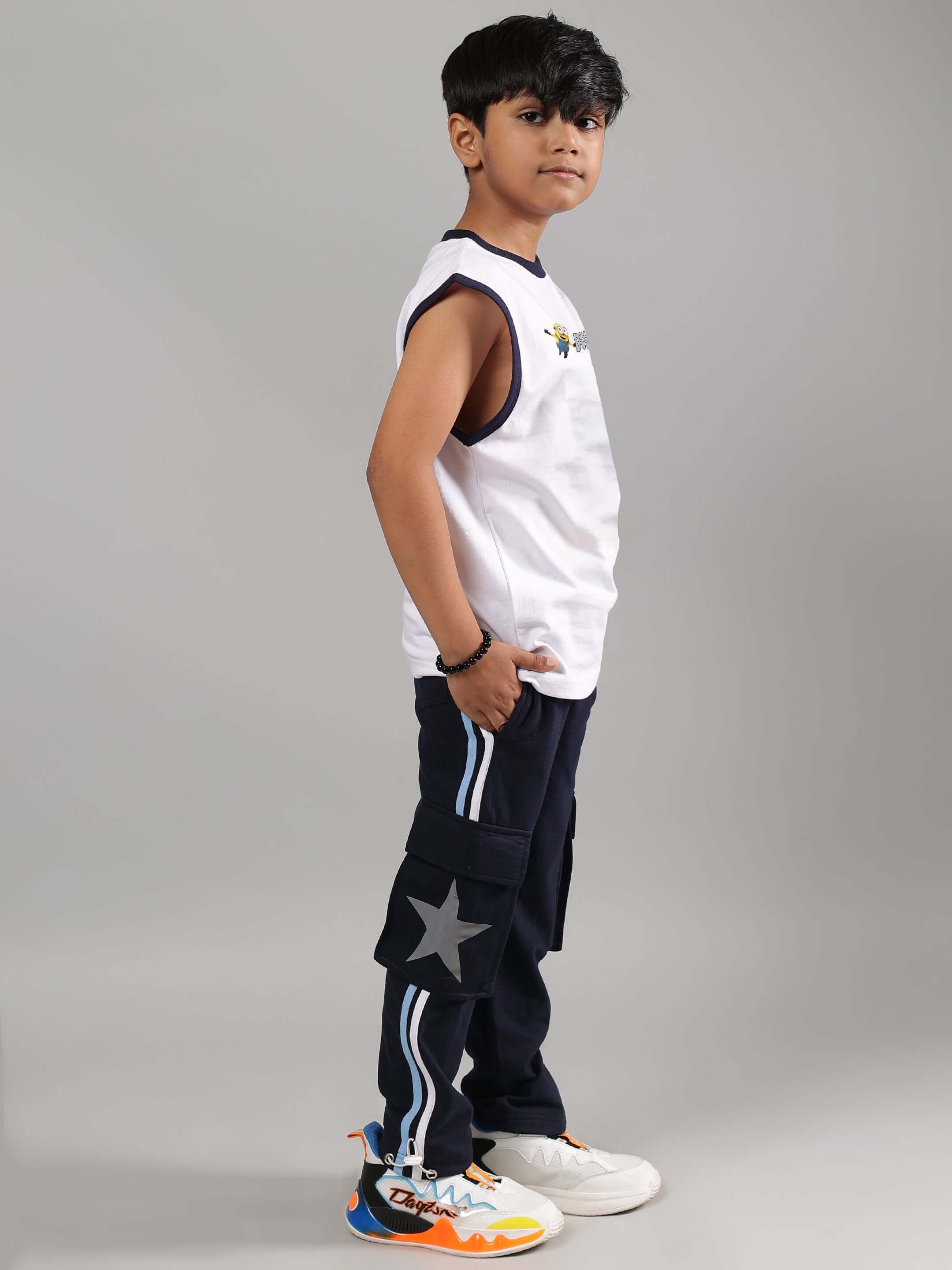 Child in ROBO MINIONS CO-ORD FOR BOYS GIRLS WHITE NAVY outfit, featuring a stylish white top and navy pants with star detail.
