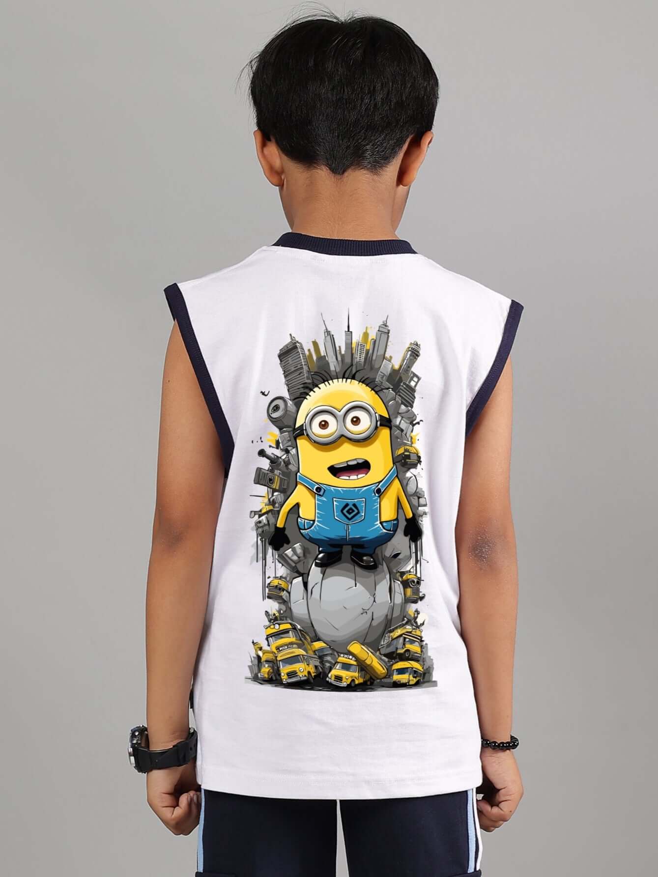 Child wearing white Robo Minions T-shirt with cityscape design on the back.