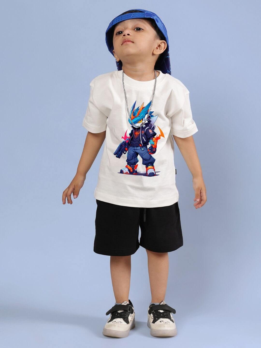 Child wearing Robo Super Co-ord Set in off white T-shirt with colorful robot print and black shorts, styled with a blue cap.