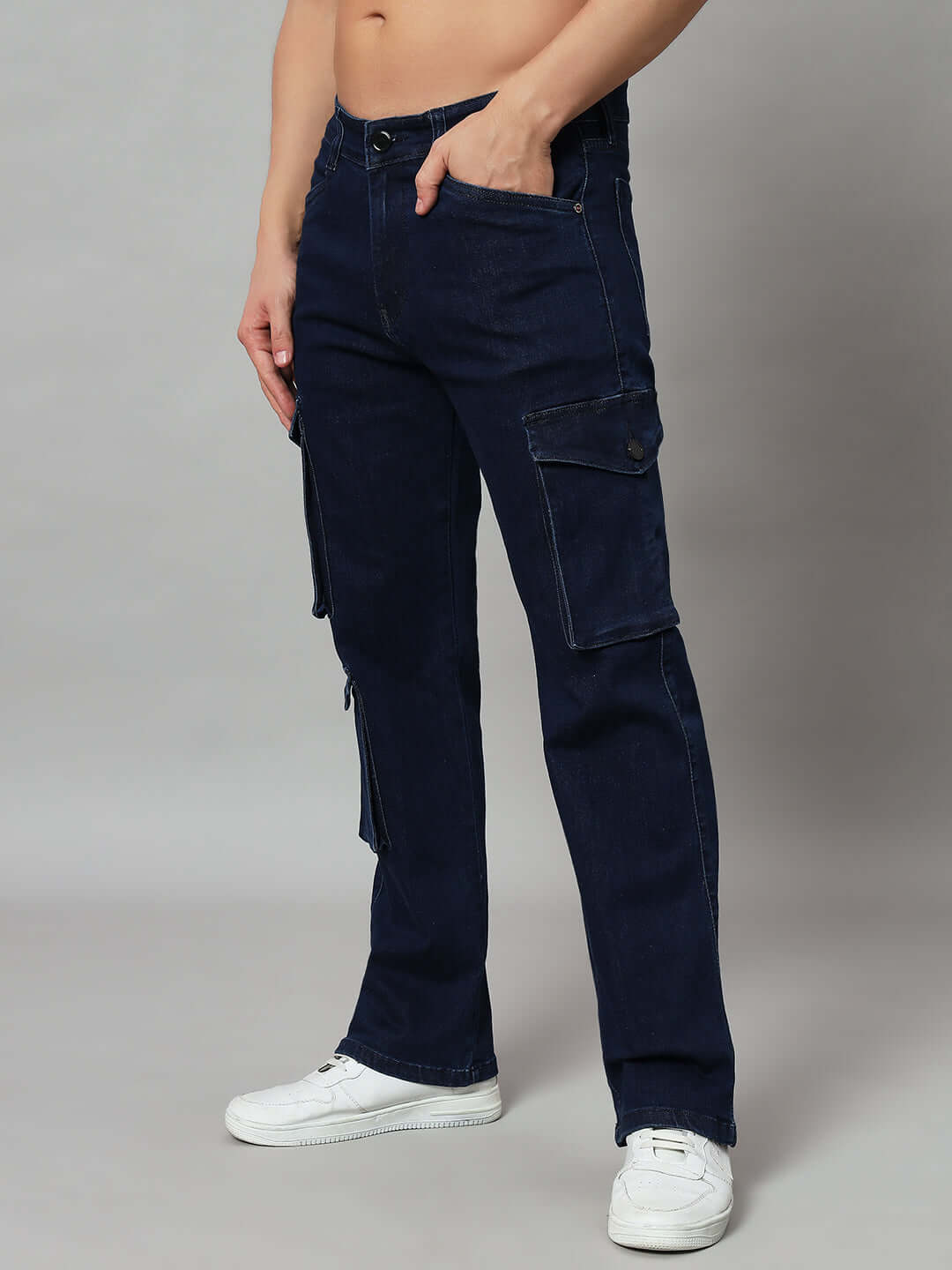 Model wearing navy relaxed denim cargo jeans with pockets, showcasing casual style and comfort. Custom fit options available by DUDS.