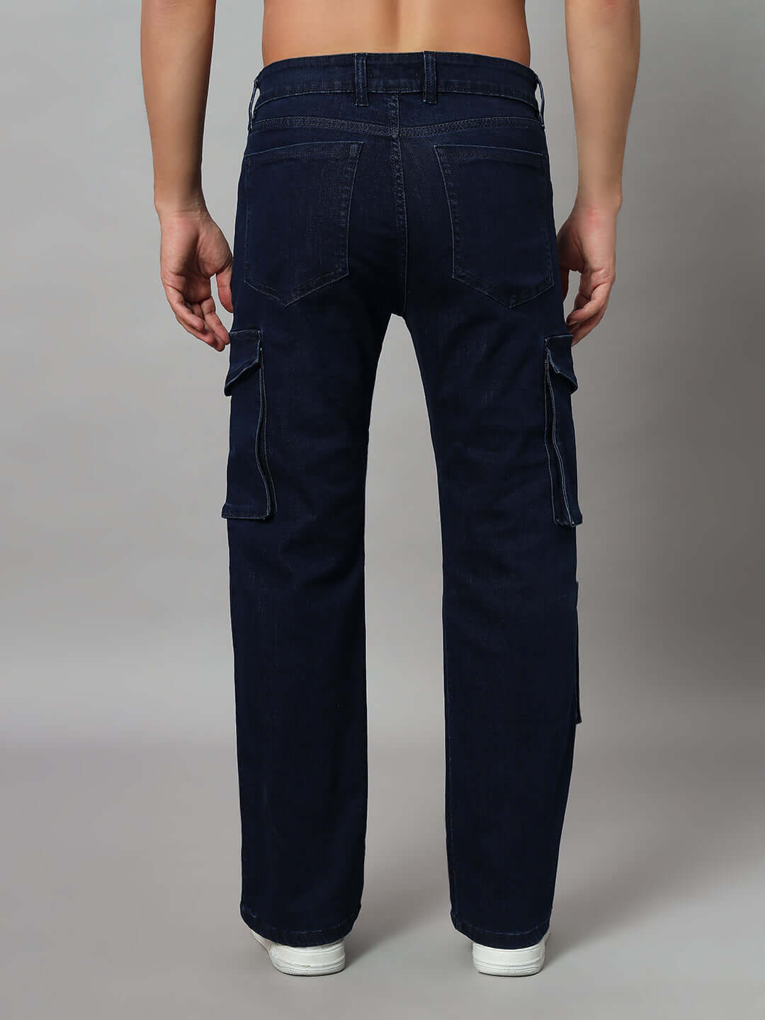 Rear view of navy relaxed denim cargo jeans with pockets, made-to-order by DUDS Tailors, available in custom fit options.