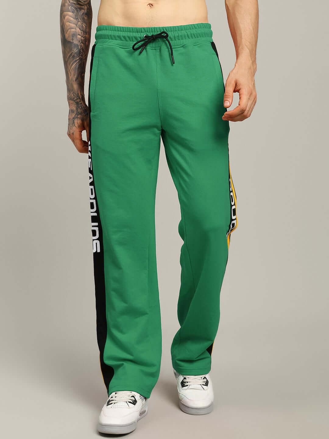 Green relaxed-fit joggers by DUDS with side lettering, featuring a drawstring waist. Made to order, customizable size available.